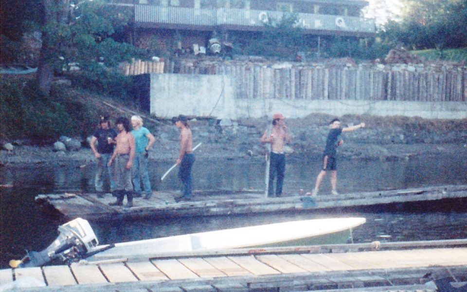 Men and women standing on an old dock