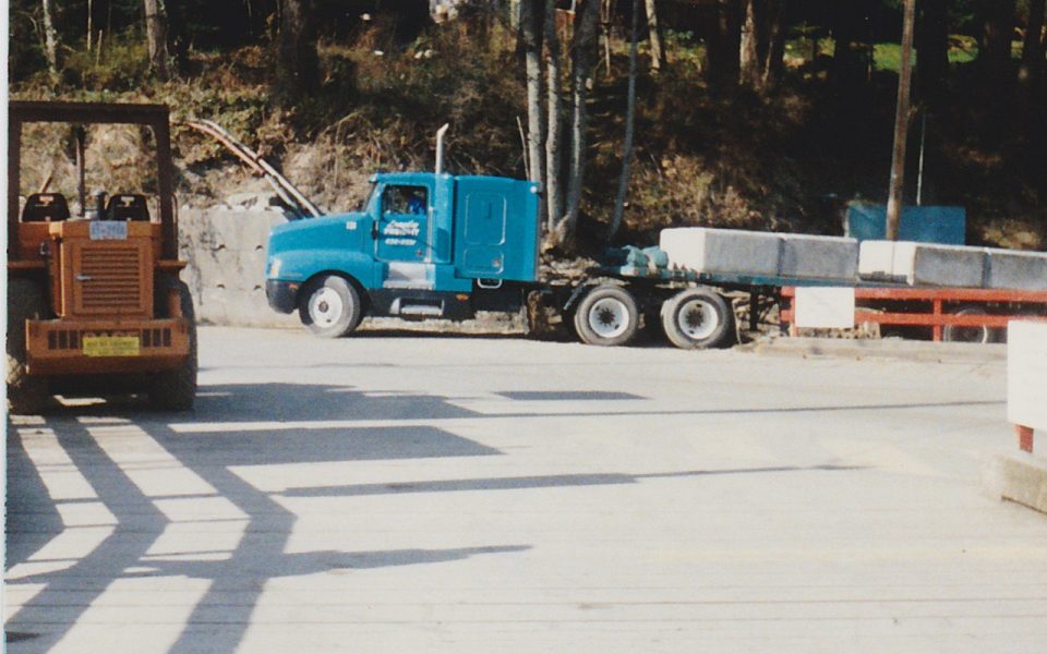 Flat bed truck bringing concrete blocks for a wall