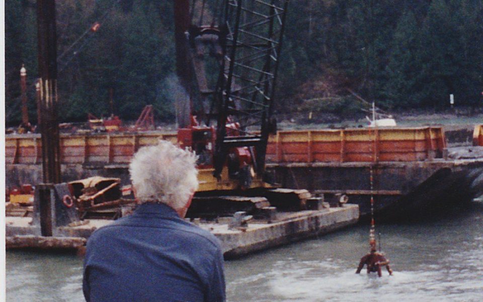 Man watching crane dredge marina