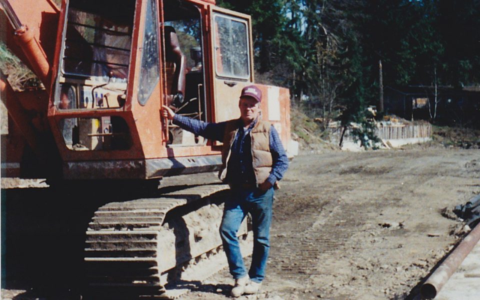 Man standing beside excavator