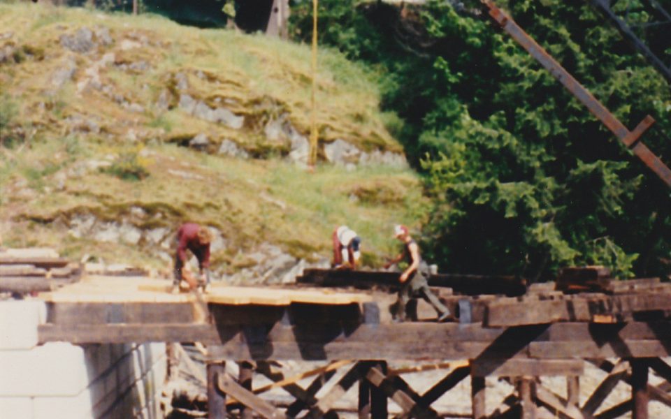 Three men working on constructing a pier