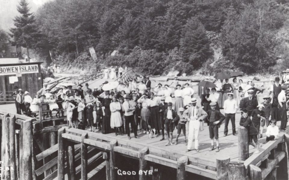 Black and white photo of people on an old dock