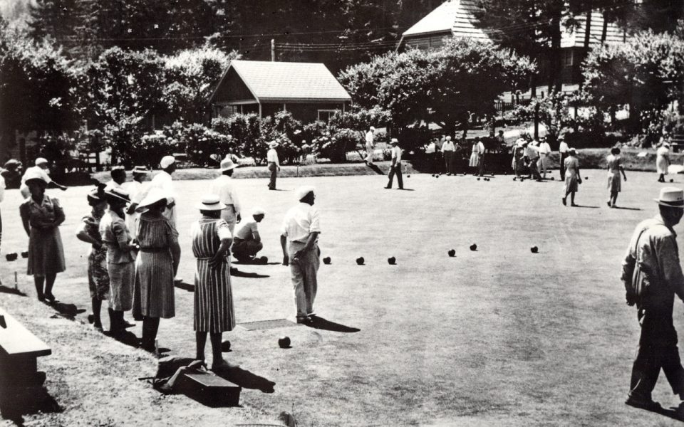 Black and white photo of people lawn bowling