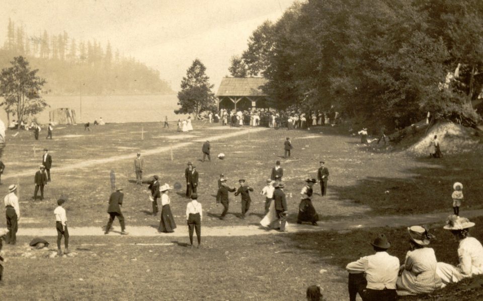 Black and white picture of field with people playing in it