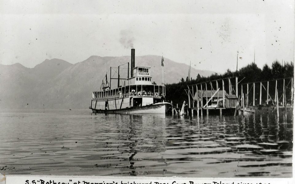 Black and white photo of old steamship docking