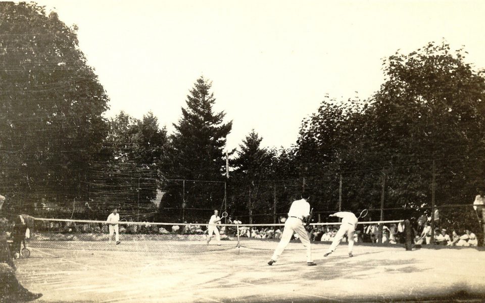 Black and white photo of men playing tennis