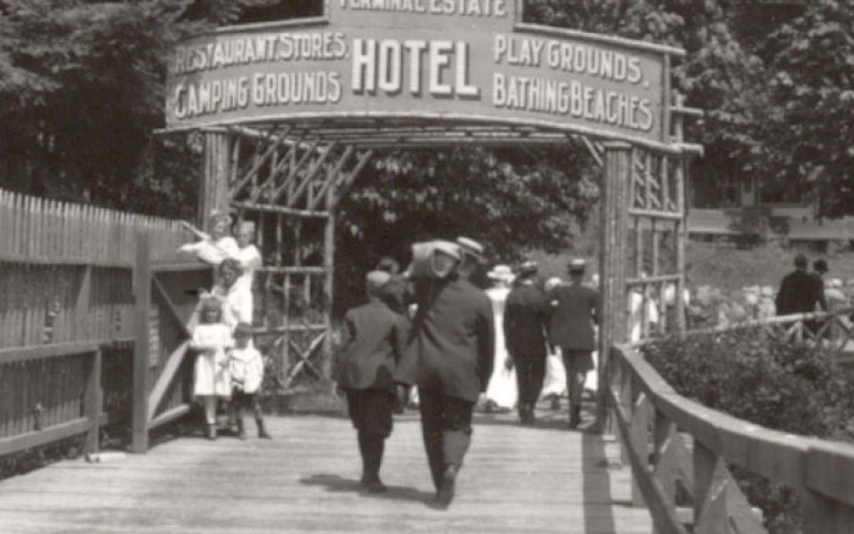Black and white photo of wooden walkway to hotel entrance