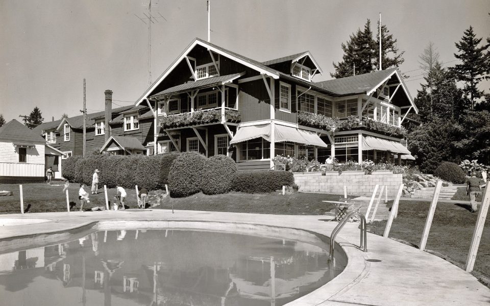 Black and white photo of hotel with swimming pool