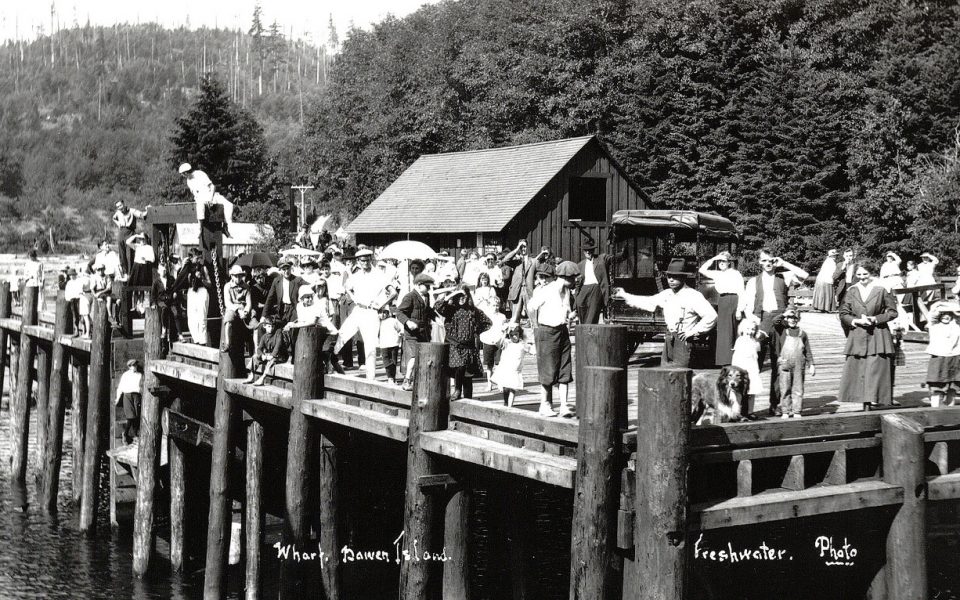 Black and white photo of wharf with people standing on it